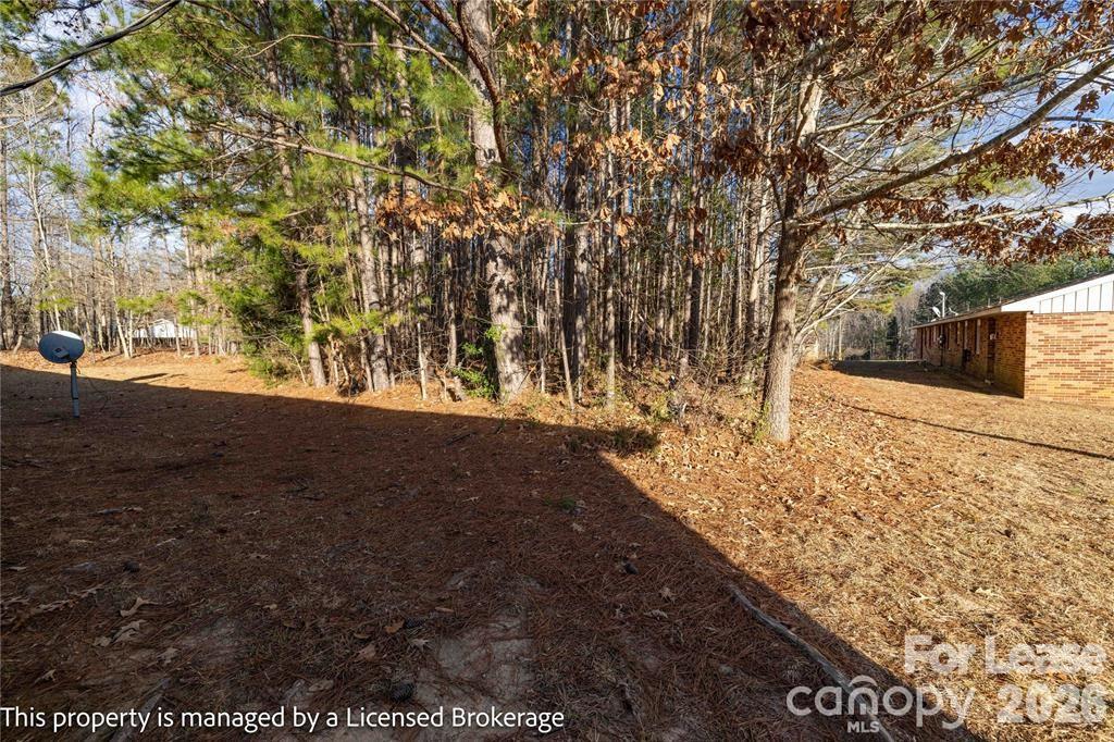 213 Roslyn Road Troy, NC 27371 - Photo 25 of 25 a view of outdoor space with deck and tree