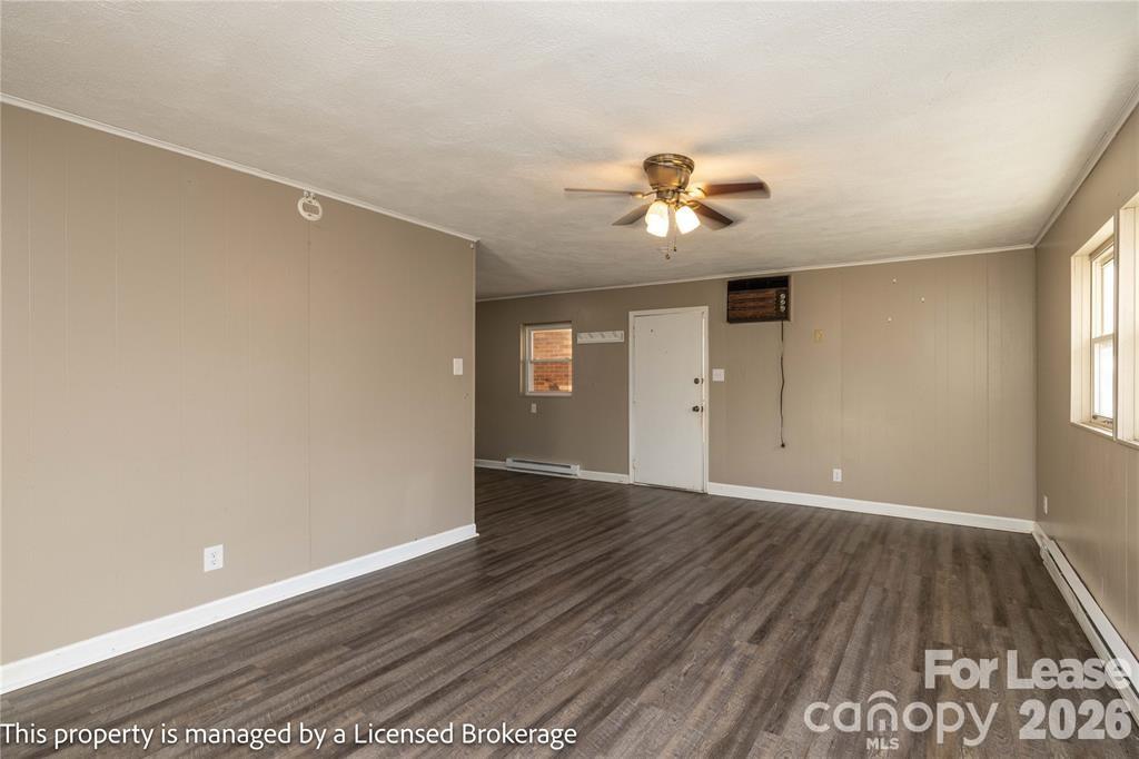 213 Roslyn Road Troy, NC 27371 - Photo 7 of 25 wooden floor in an empty room with a window