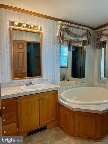 a bath tub sitting in a bathroom next to a window