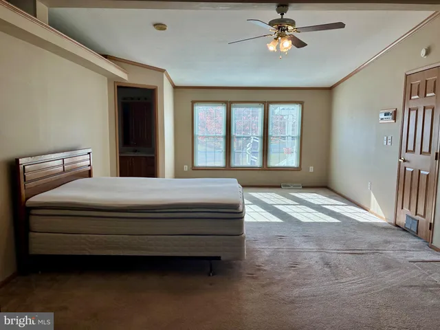 a bedroom with a bed dresser and a window