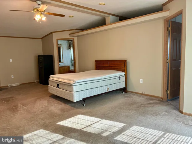 a bedroom with a bed and a ceiling fan