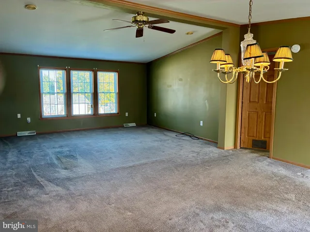 a view of an empty room with windows