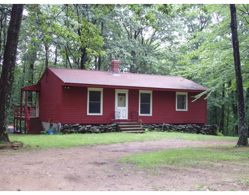261 Whitney Road Ashby, MA 01431 - Photo 1 of 12 a front view of a house with a yard