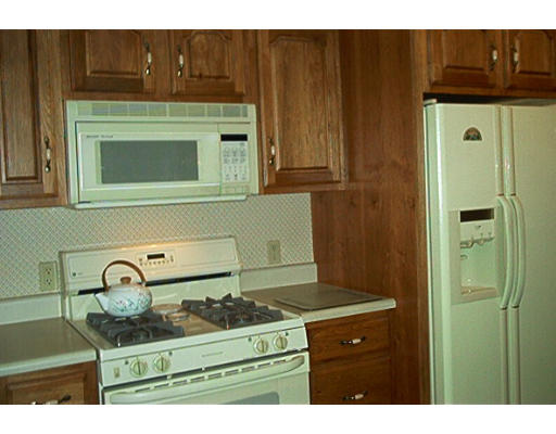 261 Whitney Road Ashby, MA 01431 - Photo 5 of 12 a kitchen with a stove and a microwave