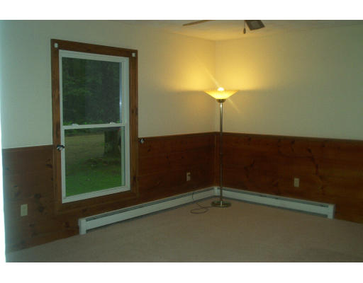 261 Whitney Road Ashby, MA 01431 - Photo 7 of 12 a view of an empty room with a door