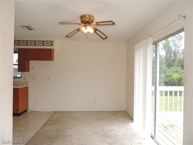 8175 Matanzas Road Fort Myers, FL 33967 - Photo 3 of 12 a view of a livingroom with a chandelier fan and a large window