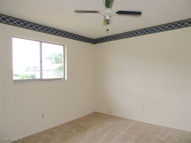 8175 Matanzas Road Fort Myers, FL 33967 - Photo 8 of 12 a view of a room with window and a ceiling fan