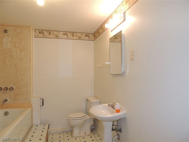 8175 Matanzas Road Fort Myers, FL 33967 - Photo 10 of 12 a bathroom with a sink a toilet and shower