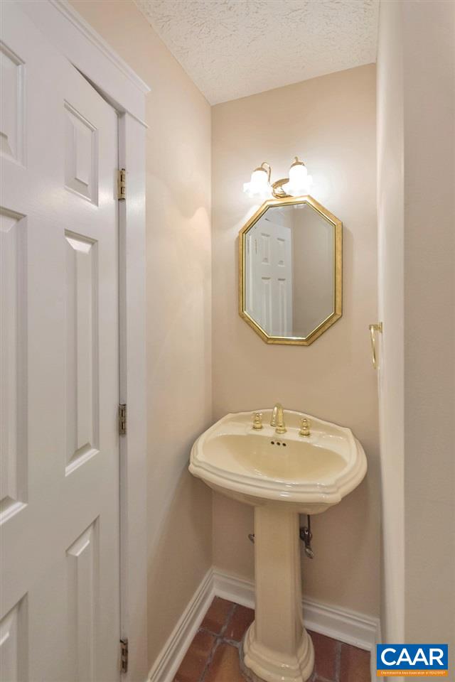 23 Ashton Road Palmyra, VA 22963 - Photo 14 of 27 a bathroom with a sink a mirror and shower
