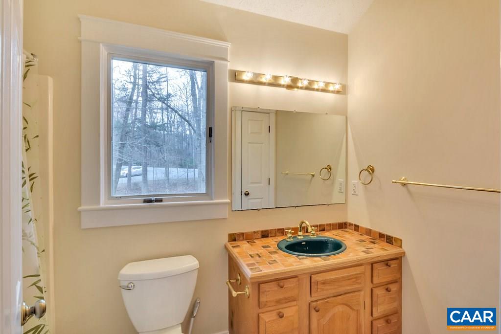 23 Ashton Road Palmyra, VA 22963 - Photo 17 of 27 a bathroom with a stove a sink and a window