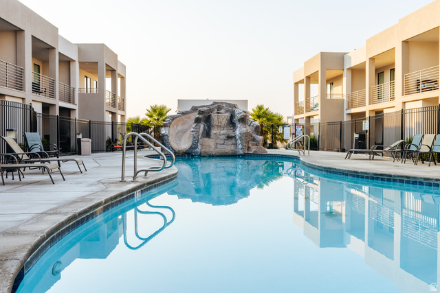 1122 South 1790th West, Unit 1 St. George, UT 84770 - Photo 34 of 37 Expansive outdoor pool area featuring a curved swimming pool with integrated rock formation and waterslide