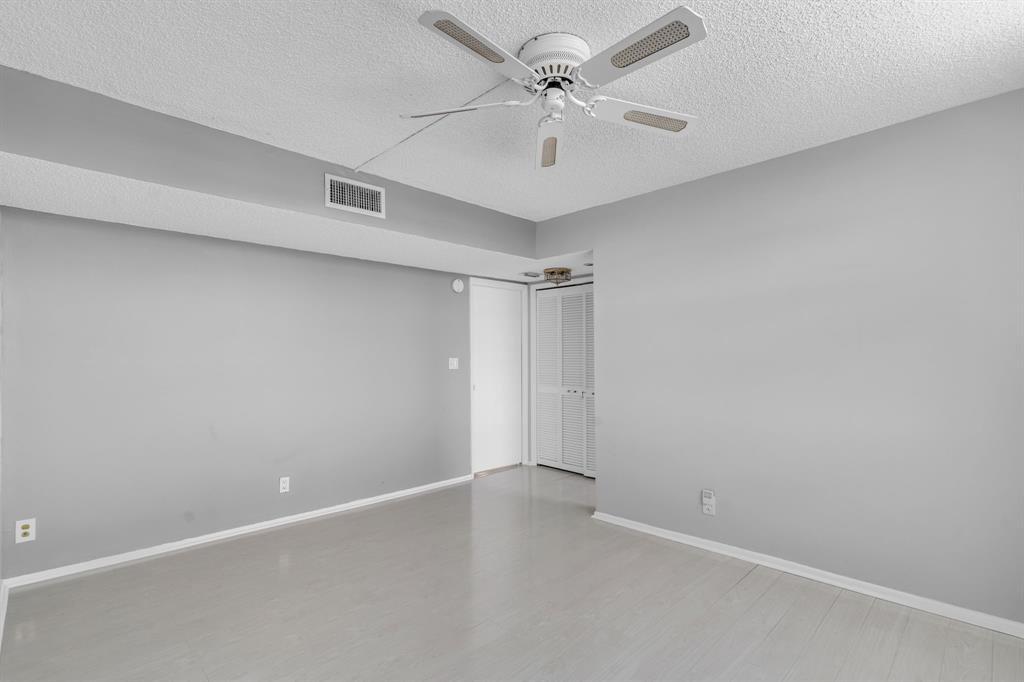 4020 West Palm Aire Drive, Unit 312 Pompano Beach, FL 33069 - Photo 14 of 36 an empty room with a ceiling fan and a window