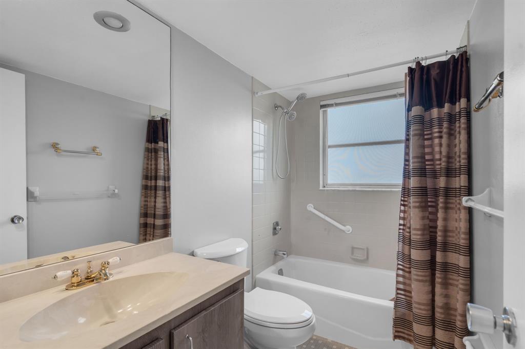 4020 West Palm Aire Drive, Unit 312 Pompano Beach, FL 33069 - Photo 16 of 36 a bathroom with a sink a toilet and shower