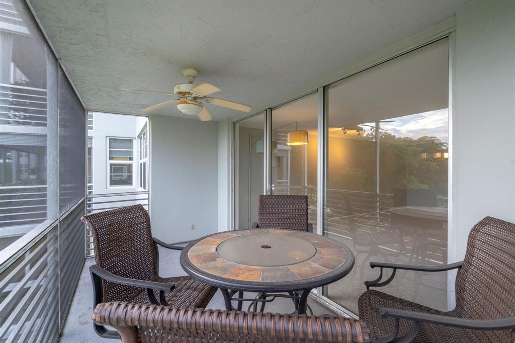 4020 West Palm Aire Drive, Unit 312 Pompano Beach, FL 33069 - Photo 23 of 36 a balcony with table and chairs