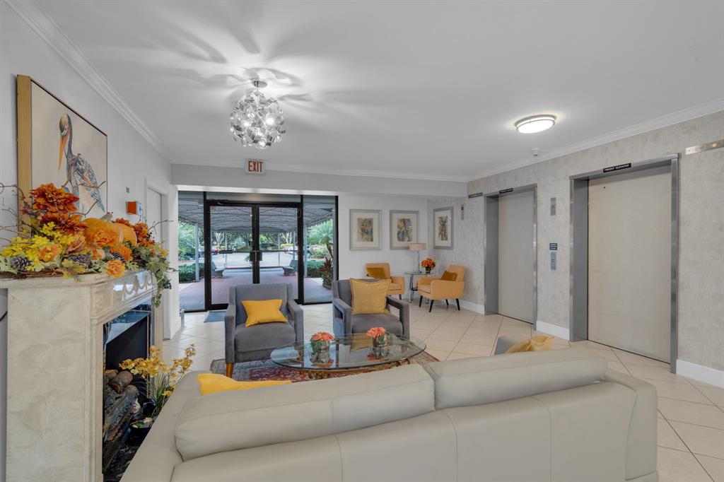 4020 West Palm Aire Drive, Unit 312 Pompano Beach, FL 33069 - Photo 26 of 36 a living room with furniture fireplace and large windows