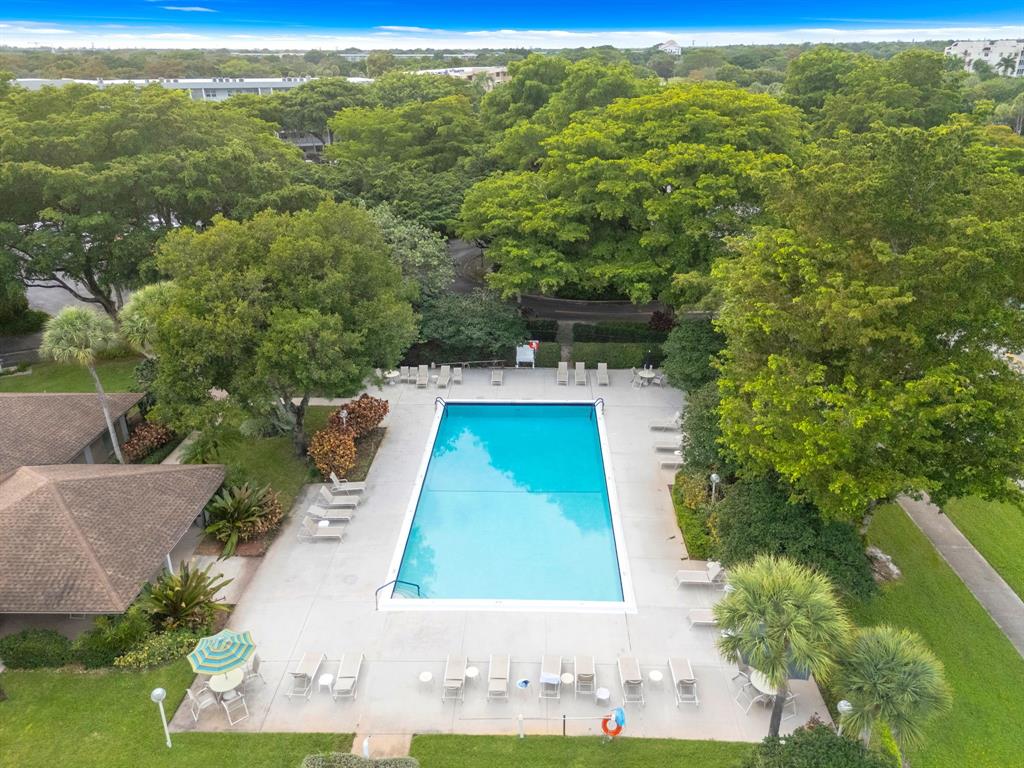 4020 West Palm Aire Drive, Unit 312 Pompano Beach, FL 33069 - Photo 4 of 36 a view of a swimming pool with a yard