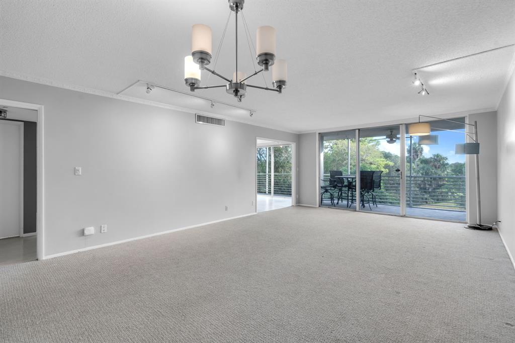 4020 West Palm Aire Drive, Unit 312 Pompano Beach, FL 33069 - Photo 6 of 36 a view of an empty room with a window