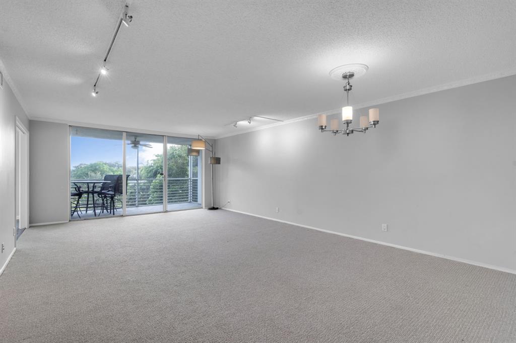4020 West Palm Aire Drive, Unit 312 Pompano Beach, FL 33069 - Photo 7 of 36 en empty room with windows and outdoor view