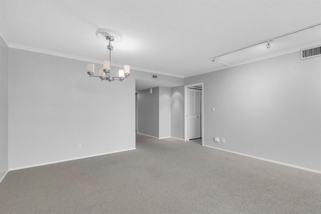 4020 West Palm Aire Drive, Unit 312 Pompano Beach, FL 33069 - Photo 9 of 36 a view of an empty room with chandelier