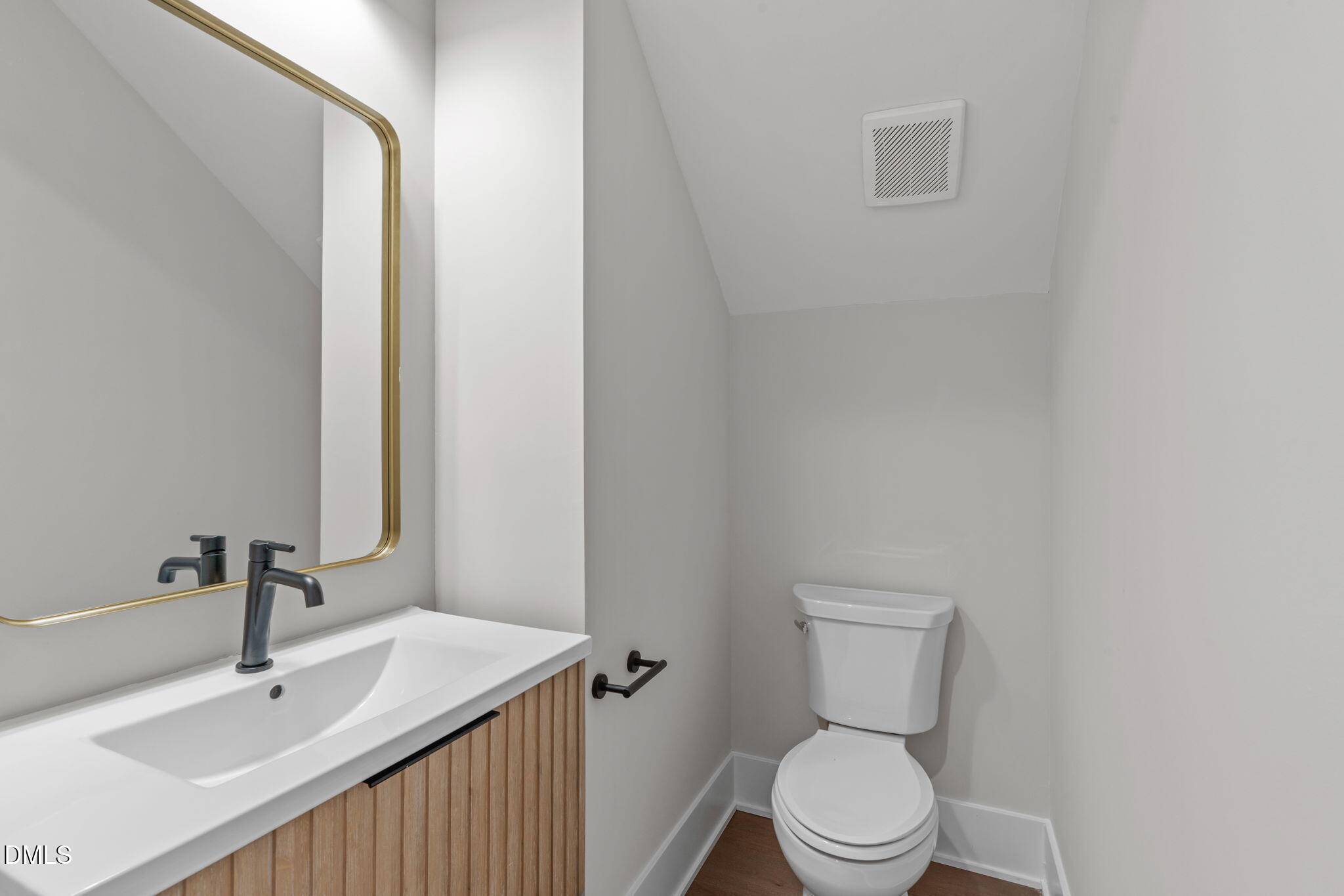 639 Conover Road, Unit B Durham, NC 27703 - Photo 13 of 48 a bathroom with a sink a toilet and a mirror