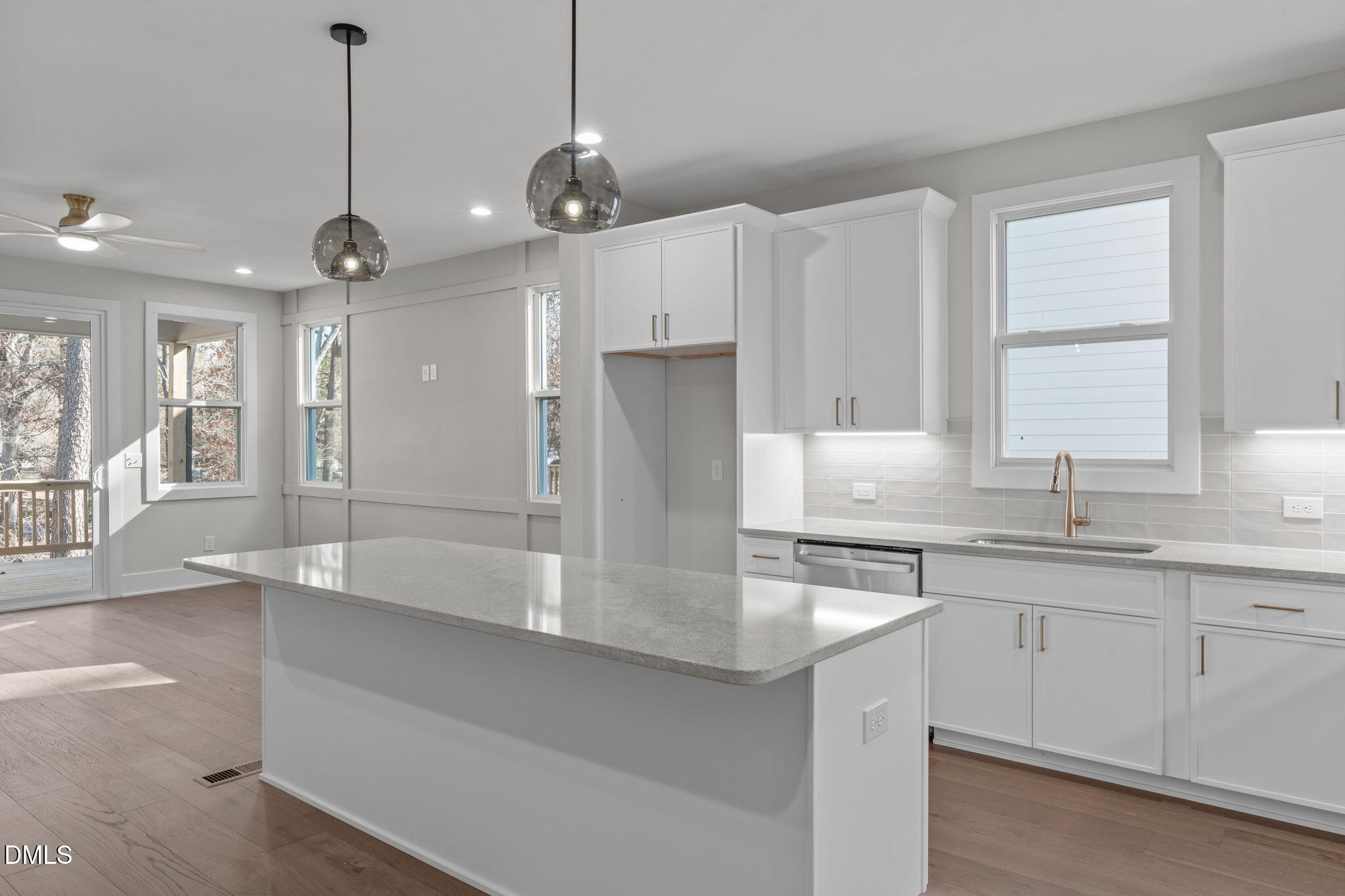 639 Conover Road, Unit B Durham, NC 27703 - Photo 15 of 48 a large kitchen with granite countertop a sink stainless steel appliances and cabinets