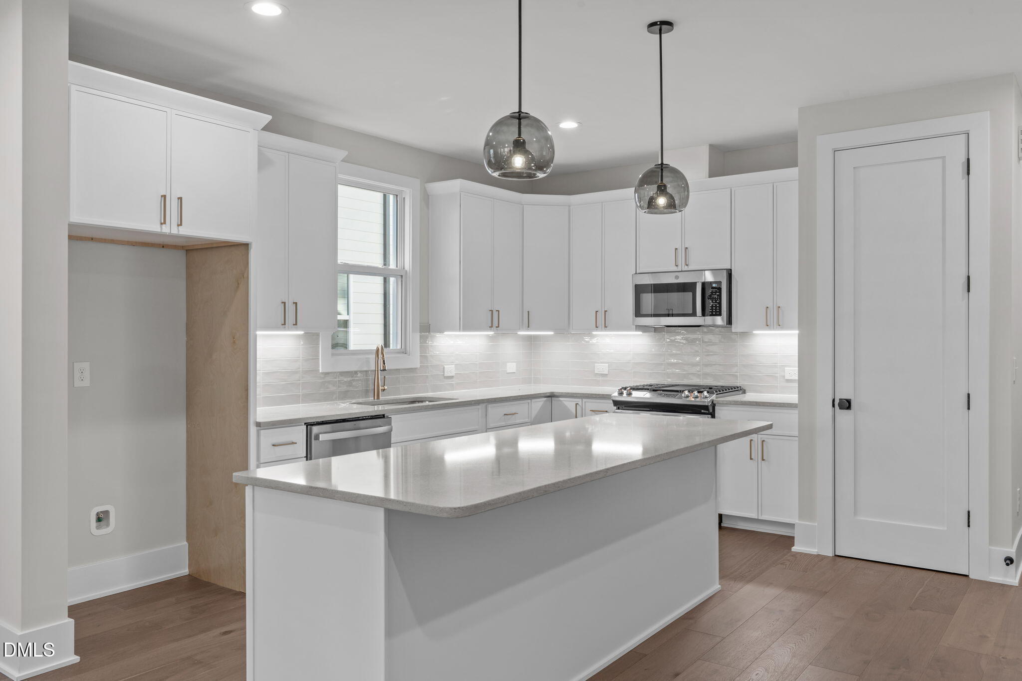 639 Conover Road, Unit B Durham, NC 27703 - Photo 16 of 48 a kitchen with stainless steel appliances granite countertop a sink a stove and a refrigerator