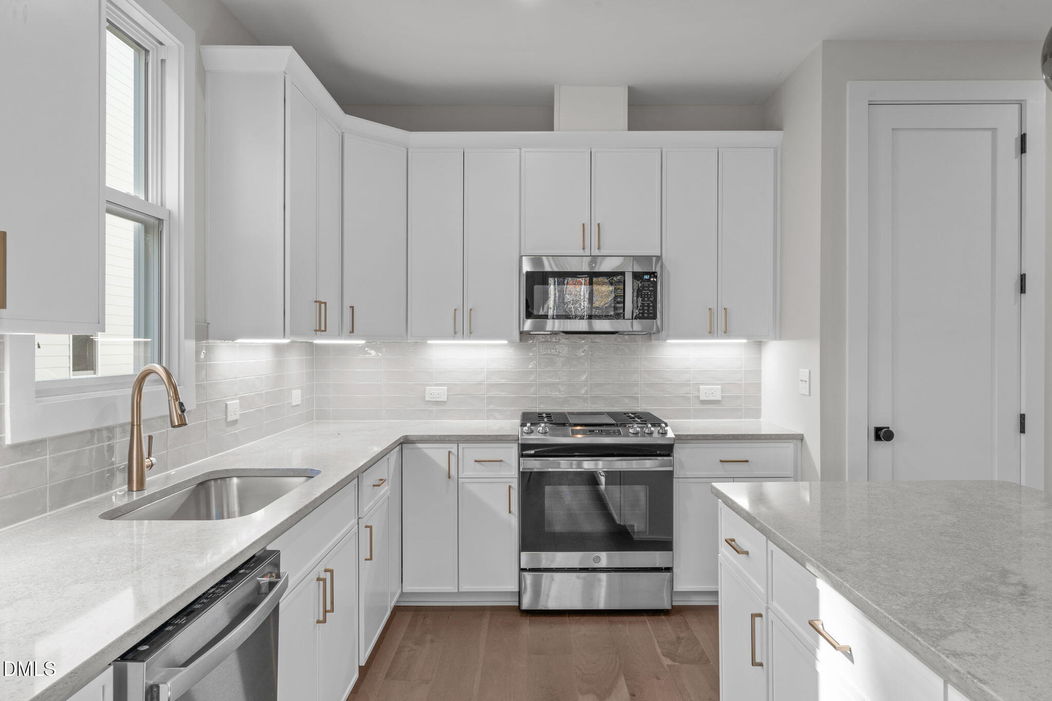 639 Conover Road, Unit B Durham, NC 27703 - Photo 17 of 48 a kitchen with appliances a sink and cabinets