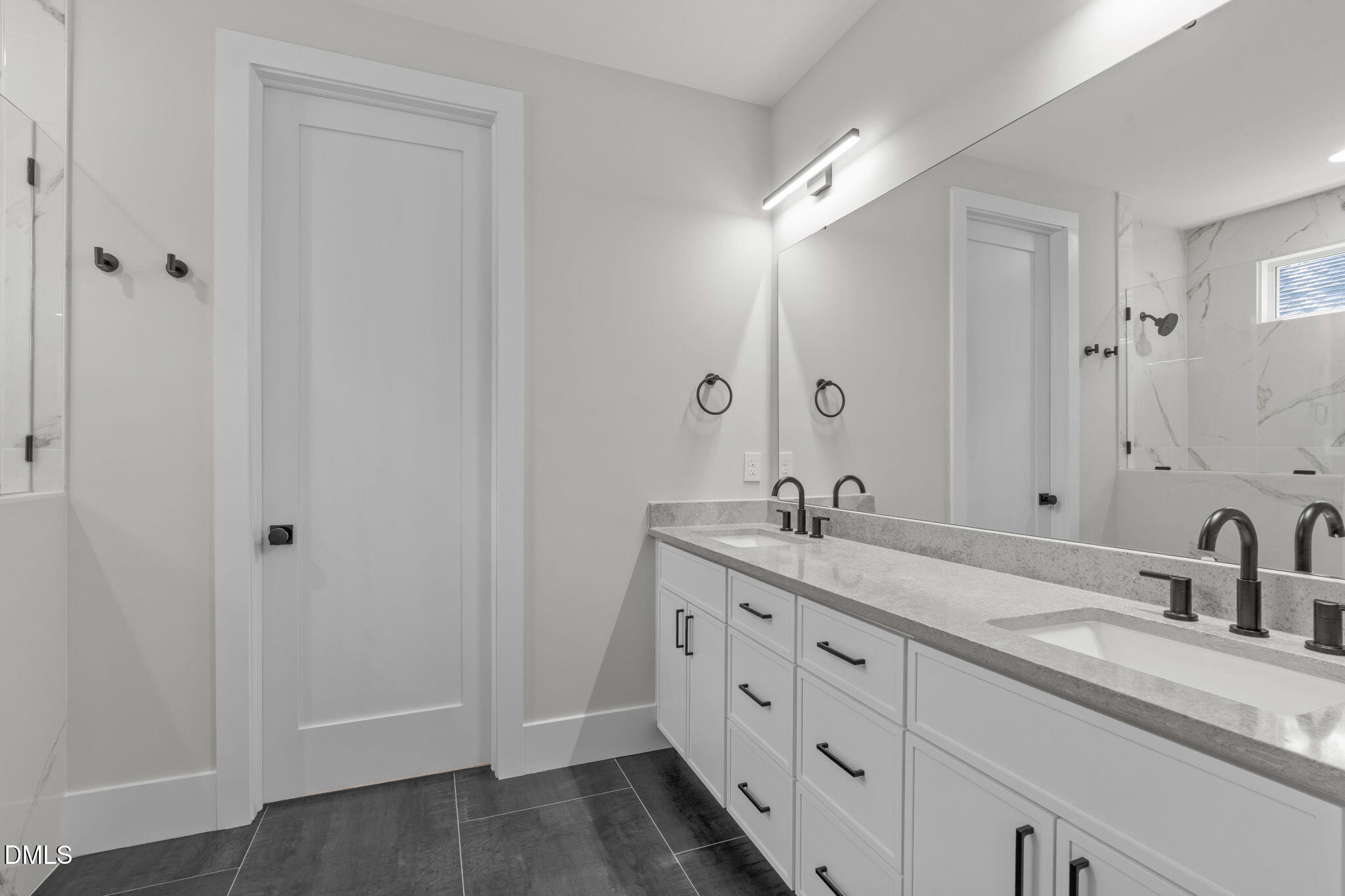 639 Conover Road, Unit B Durham, NC 27703 - Photo 28 of 48 a bathroom with double sink and a mirror