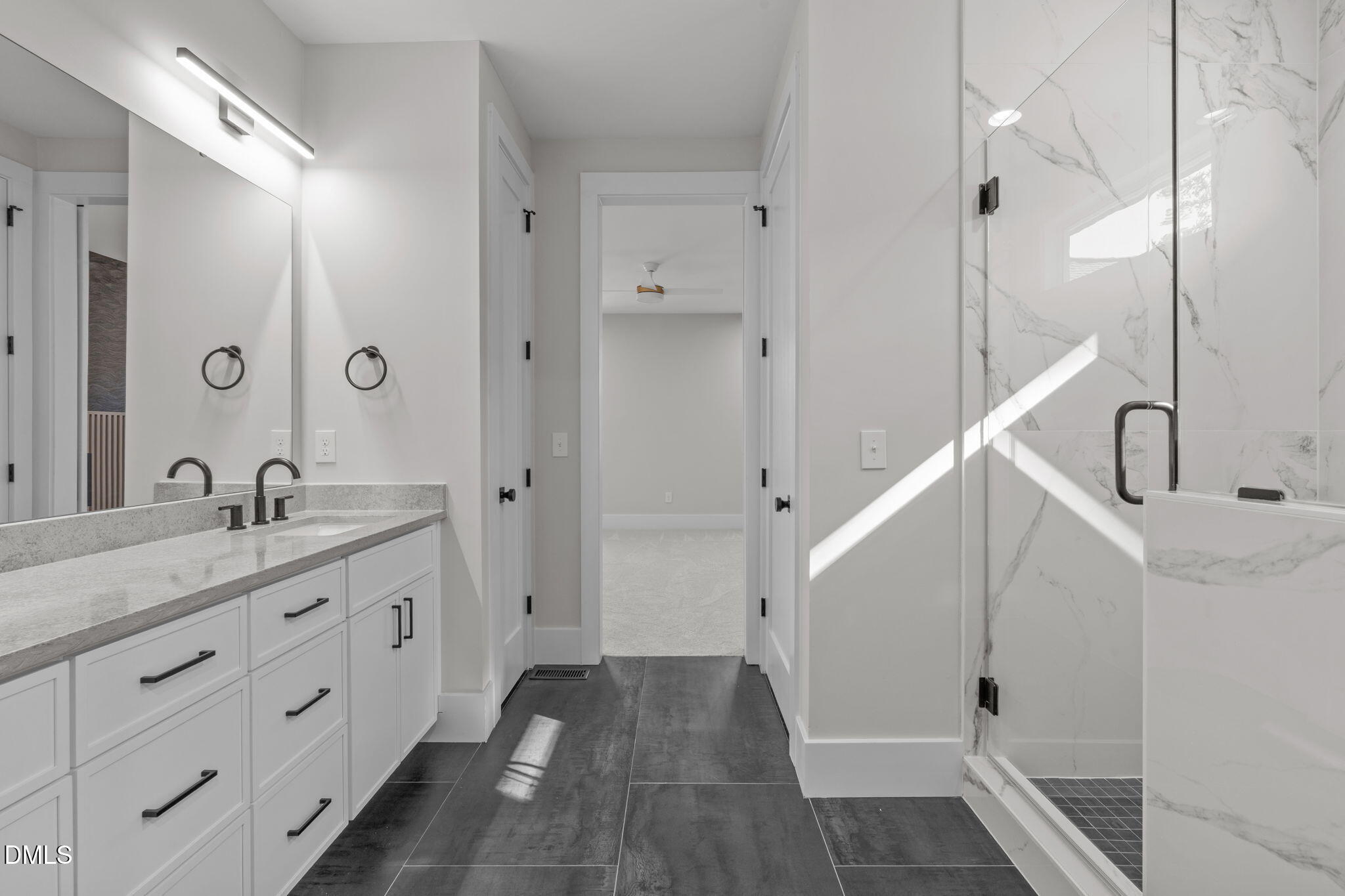 639 Conover Road, Unit B Durham, NC 27703 - Photo 30 of 48 a bathroom with a double vanity sink and mirror with shower