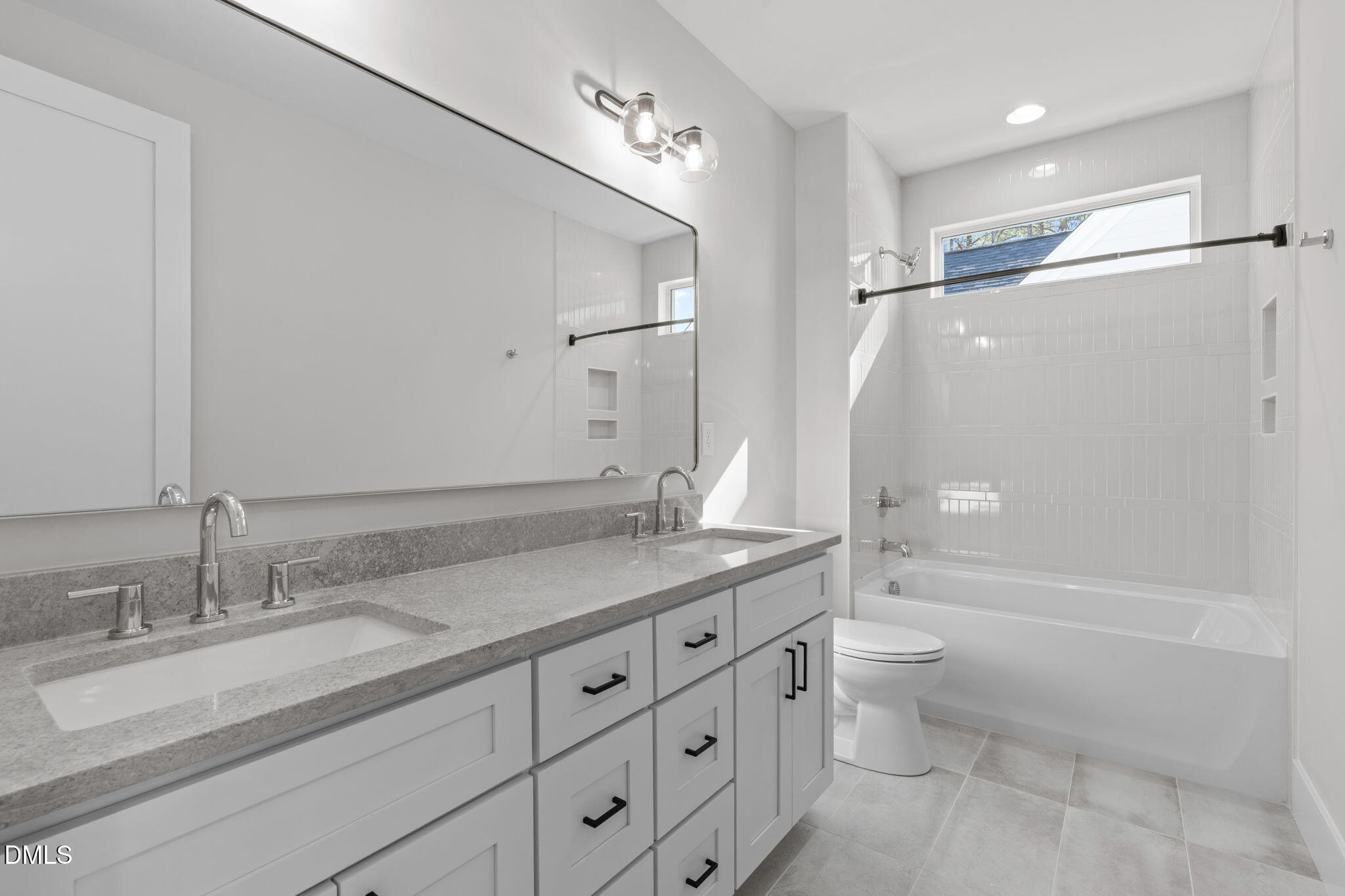 639 Conover Road, Unit B Durham, NC 27703 - Photo 35 of 48 a bathroom with a granite countertop sink a toilet a mirror and shower