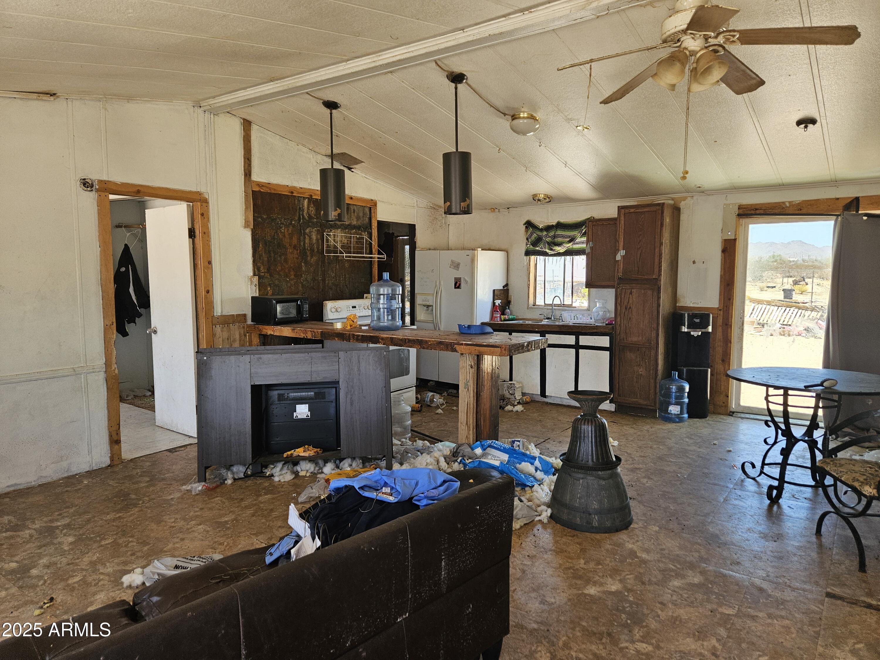 684 South Conejo Road Maricopa, AZ 85139 - Photo 2 of 10 a living room with furniture and a fireplace