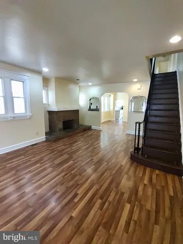 a view of a room with wooden floor