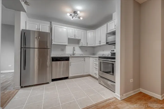 a kitchen with a stove a refrigerator and a sink