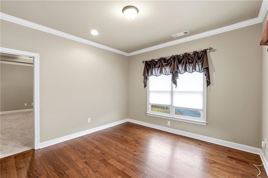 265 Trecastle Square Canton, GA 30114 - Photo 20 of 47 an empty room with wooden floor and windows