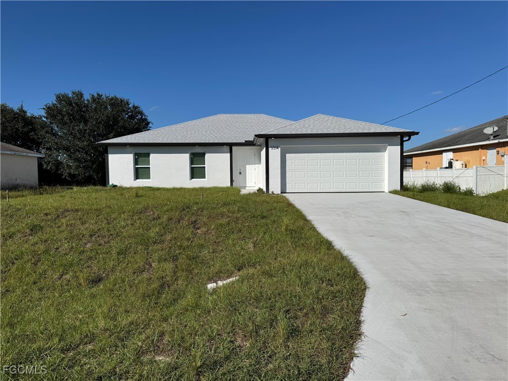 a view of a house with a yard and garage