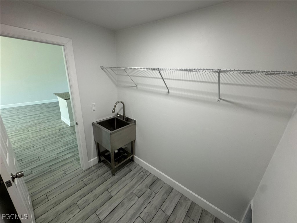 3314 36th Street Southwest Lehigh Acres, FL 33976 - Photo 12 of 23 a view of a room with racks on the wall