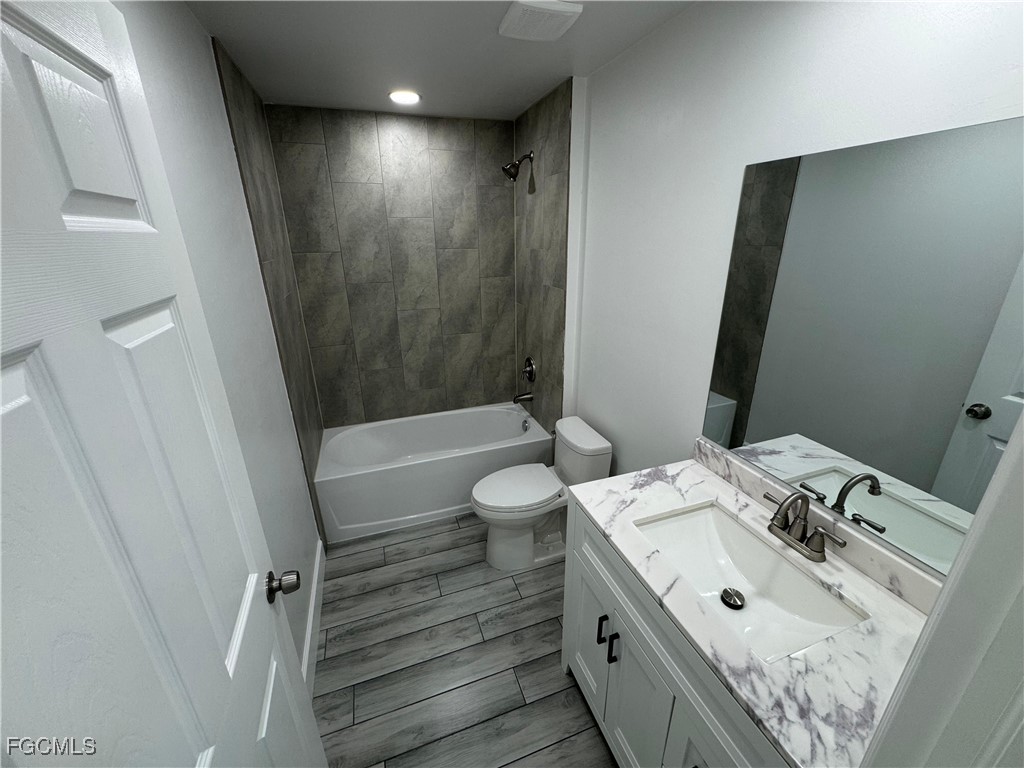 3314 36th Street Southwest Lehigh Acres, FL 33976 - Photo 13 of 23 a bathroom with a sink a toilet and shower