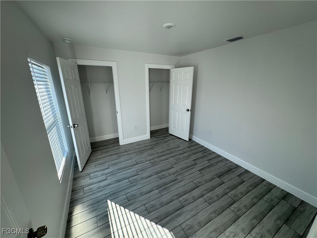 3314 36th Street Southwest Lehigh Acres, FL 33976 - Photo 18 of 23 a view of a hallway with wooden floor and stairs
