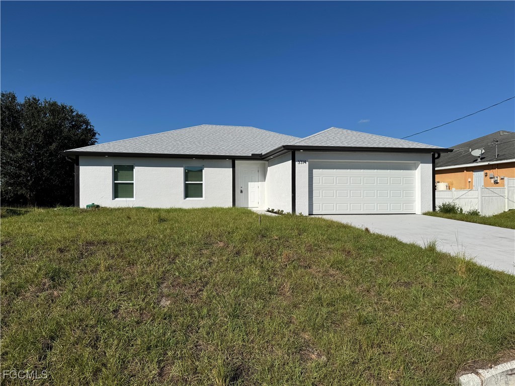 3314 36th Street Southwest Lehigh Acres, FL 33976 - Photo 2 of 23 a front view of a house with a yard