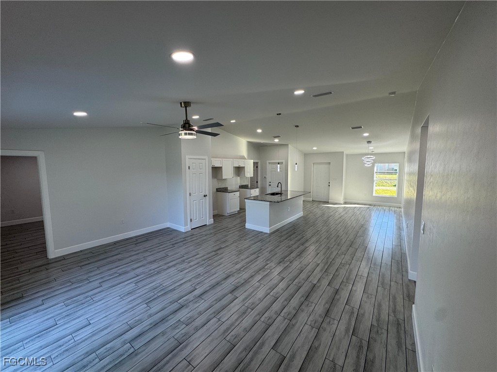 3314 36th Street Southwest Lehigh Acres, FL 33976 - Photo 5 of 23 a view of a kitchen with wooden floor