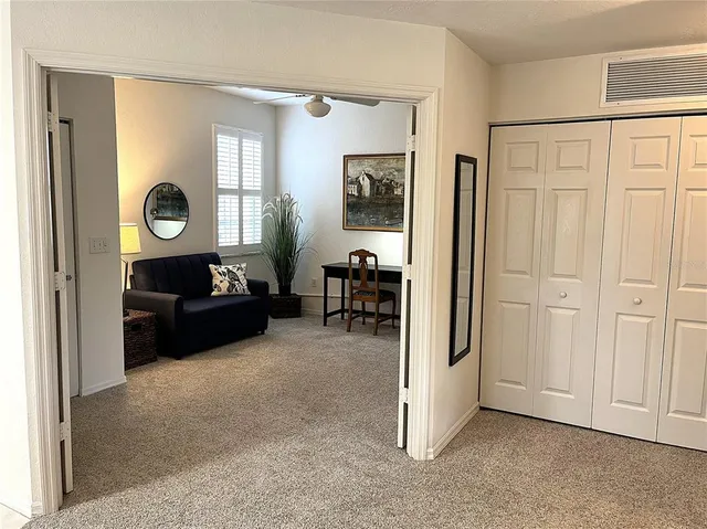a living room with furniture and a closet
