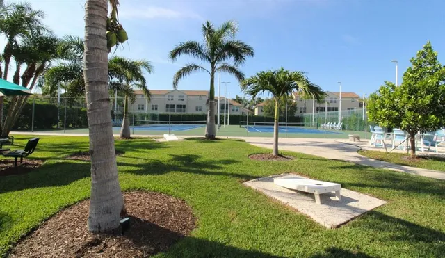 a view of a park with swings and palm trees