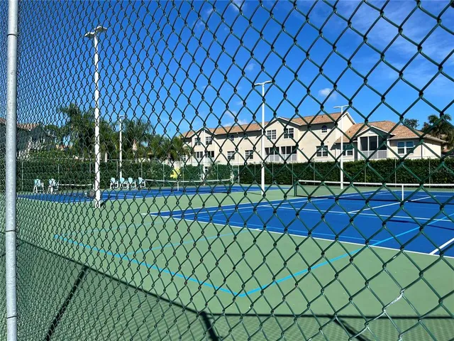 a view of a yard and wooden fence