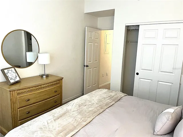 a bedroom with a bed and a mirror