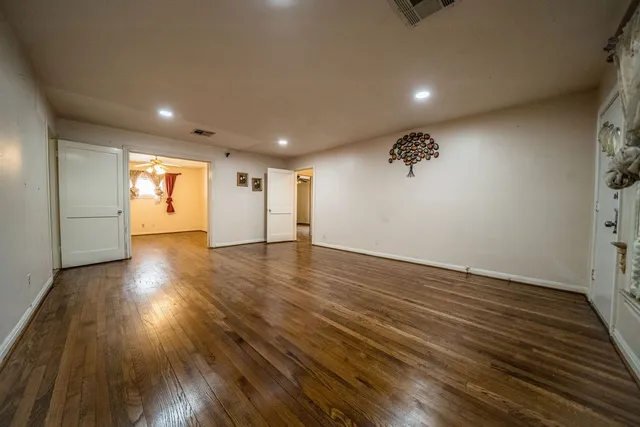 a view of a room with wooden floors and stairs