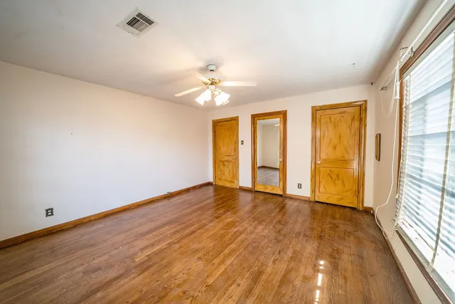 wooden floor in an empty room with a window