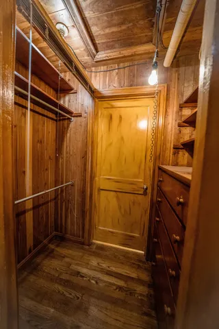 a view of walk in closet with empty racks