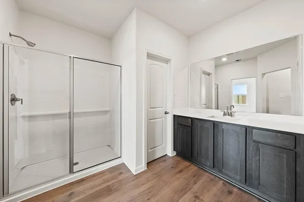 a bathroom with a double vanity sink and mirror