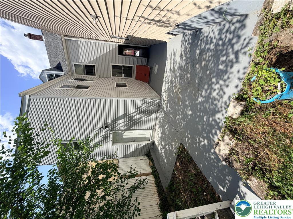 718 Ferry Street Easton, PA 18042 - Photo 30 of 37 A well-maintained side exterior offers practical outdoor space and building access.