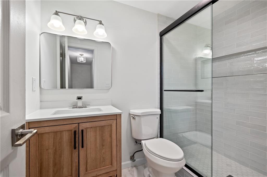 200 Pinchtown Road Pittsburgh, PA 15236 - Photo 13 of 26 a bathroom with a toilet a sink and mirror